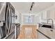 The spacious kitchen features stainless steel appliances, granite countertops, and a view into the dining area at 1186 Hawthorn Ln, Grayson, GA 30017