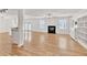Open-concept living room featuring wood floors, a fireplace, and ample natural light with views of the kitchen at 1186 Hawthorn Ln, Grayson, GA 30017