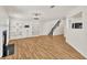 Bright, open living area with fireplace, built-in shelving, and wood flooring with access to the kitchen at 1186 Hawthorn Ln, Grayson, GA 30017