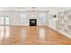 Spacious living room with a fireplace, wood floors, large windows, and a stylish ceiling fan at 1186 Hawthorn Ln, Grayson, GA 30017