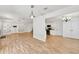 Open-concept living space with stylish lighting, and hardwood floors seamlessly connects the kitchen and living areas at 1186 Hawthorn Ln, Grayson, GA 30017