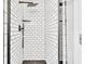 Modern shower with white subway tile, black hardware, and a black hexagon tile floor at 1186 Hawthorn Ln, Grayson, GA 30017