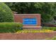 Brick community sign for Hawthorn Glen with manicured landscaping and colorful flowerbed at 1186 Hawthorn Ln, Grayson, GA 30017