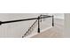 Staircase featuring white balusters and a black handrail, adding a touch of elegance to the home's interior at 1186 Hawthorn Ln, Grayson, GA 30017