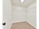 Bright walk-in closet featuring neutral carpet, white walls, shelving, and a skylight at 1186 Hawthorn Ln, Grayson, GA 30017