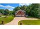 A stunning aerial view of a landscaped property reveals a home with a two-car garage and a long driveway at 125 Legacy Way, Oxford, GA 30054