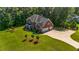 Aerial view showcases a home on a large, well-manicured lot, complete with mature trees at 125 Legacy Way, Oxford, GA 30054