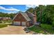 Aerial view features a well-maintained home with a two-car garage, surrounded by lush landscaping at 125 Legacy Way, Oxford, GA 30054