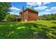 A spacious backyard offers ample green space, complemented by a brick exterior and a deck for outdoor enjoyment at 125 Legacy Way, Oxford, GA 30054