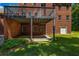 An inviting backyard features a covered patio beneath a deck, set against a brick facade at 125 Legacy Way, Oxford, GA 30054