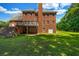 Backyard view showcasing a deck, patio, and lush green lawn, perfect for outdoor entertaining at 125 Legacy Way, Oxford, GA 30054