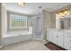 Bathroom featuring a tub, shower, and double vanity at 125 Legacy Way, Oxford, GA 30054