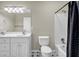 Bathroom featuring double sinks, a shower-tub combo, and black and white tile at 125 Legacy Way, Oxford, GA 30054