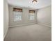Bedroom featuring neutral walls, neutral carpet, and two windows at 125 Legacy Way, Oxford, GA 30054