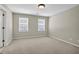 Empty bedroom with neutral carpet and two windows at 125 Legacy Way, Oxford, GA 30054