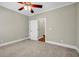Bedroom featuring neutral walls and carpeted flooring with an open doorway to a bathroom at 125 Legacy Way, Oxford, GA 30054