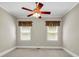 Bedroom with a ceiling fan and natural light from two windows at 125 Legacy Way, Oxford, GA 30054