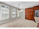 Bright dining area with tile flooring, a chandelier, and views from large windows at 125 Legacy Way, Oxford, GA 30054