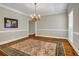 Elegant dining room with hardwood floors, chandelier, and large windows at 125 Legacy Way, Oxford, GA 30054