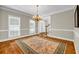 Charming dining room featuring hardwood floors, a chandelier, and natural light at 125 Legacy Way, Oxford, GA 30054