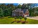 Lovely two-story brick house with a well-maintained yard and an attached two-car garage at 125 Legacy Way, Oxford, GA 30054