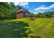 Expansive lawn surrounds this two-story brick home with mature landscaping, offering serene suburban living at 125 Legacy Way, Oxford, GA 30054