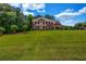 Beautiful two-story brick home featuring a spacious front yard with mature landscaping and classic architectural details at 125 Legacy Way, Oxford, GA 30054