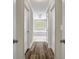 Hallway with wood floors and view of the bathroom at 125 Legacy Way, Oxford, GA 30054