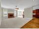 Comfortable living room with fireplace and carpeted area; hardwood entry to kitchen at 125 Legacy Way, Oxford, GA 30054