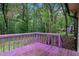 Exterior back deck with purple railing overlooks a yard with lush trees and greenery at 273 Apalachee Church Rd, Auburn, GA 30011