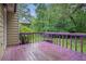 Exterior back deck with purple railing with lush trees and greenery in the background at 273 Apalachee Church Rd, Auburn, GA 30011