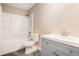 Bathroom featuring a modern gray vanity, shower with white surround, and toilet at 273 Apalachee Church Rd, Auburn, GA 30011