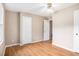 Bedroom featuring laminate flooring, neutral walls, a ceiling fan, and two white doors at 273 Apalachee Church Rd, Auburn, GA 30011