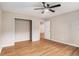 Bedroom with laminate flooring, neutral walls, ceiling fan, and view to adjacent room at 273 Apalachee Church Rd, Auburn, GA 30011