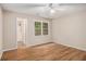 Light-filled bedroom with hardwood floors, ceiling fan, and en-suite bathroom at 273 Apalachee Church Rd, Auburn, GA 30011