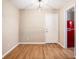 Bright entryway with wood floors, neutral walls, with red refrigerator in the nearby kitchen at 273 Apalachee Church Rd, Auburn, GA 30011