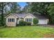 Charming home with manicured landscaping, green shutters, and an attached two-car garage at 273 Apalachee Church Rd, Auburn, GA 30011