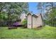 Exterior side view of home featuring a raised wooden deck painted purple, firepit and grass yard at 273 Apalachee Church Rd, Auburn, GA 30011