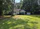 Charming single-story home with a well-maintained lawn, mature trees, and an attached two-car garage at 273 Apalachee Church Rd, Auburn, GA 30011