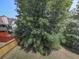Backyard features a well-maintained lawn, mature tree coverage, and partial fencing at 504 Hillcrest Cross Rd, Canton, GA 30115