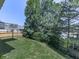 Backyard features a well-maintained lawn, mature tree coverage, and partial fencing at 504 Hillcrest Cross Rd, Canton, GA 30115