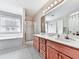 Well-lit bathroom featuring a double vanity, a soaking tub, and a separate glass-enclosed shower at 504 Hillcrest Cross Rd, Canton, GA 30115