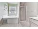 Bright bathroom with a large soaking tub, a glass-enclosed shower, and neutral décor at 504 Hillcrest Cross Rd, Canton, GA 30115