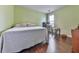 Inviting bedroom with hardwood floors, a large bed, and a dedicated desk area near the window at 504 Hillcrest Cross Rd, Canton, GA 30115