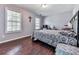 Comfortable bedroom featuring dark wood floors, two windows, and ample natural light at 504 Hillcrest Cross Rd, Canton, GA 30115