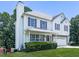 Two-story home with attached garage, well-kept lawn, and traditional architectural details at 504 Hillcrest Cross Rd, Canton, GA 30115