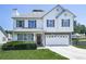 Charming two-story home with a well-manicured lawn and attached two-car garage on a sunny day at 504 Hillcrest Cross Rd, Canton, GA 30115