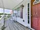 Inviting front porch with wooden floor, cozy seating, and bright natural light at 504 Hillcrest Cross Rd, Canton, GA 30115