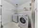 Bright laundry room with a modern washer and dryer set, plus wire shelving for storage at 504 Hillcrest Cross Rd, Canton, GA 30115