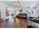 Bright living room with hardwood floors, a leather sofa, and access to the kitchen and dining area at 504 Hillcrest Cross Rd, Canton, GA 30115